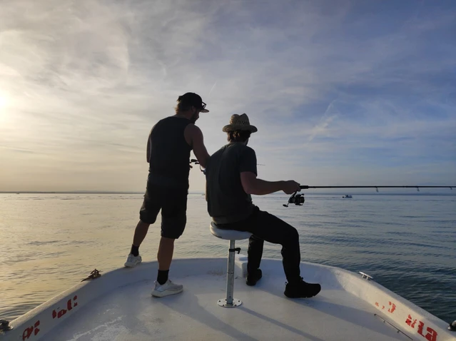 Fishing for sardines from the motorboat on Lake Garda at sunset